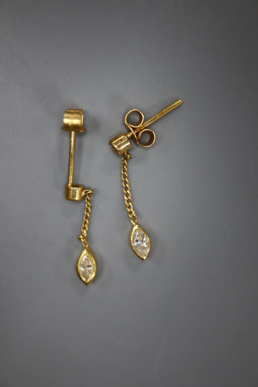 A modern pair of 18ct gold, marquise and round cut diamond set drop earrings, drop 22mm, gross 1.6 grams.